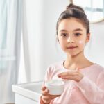 Young girl with an anti-aging product