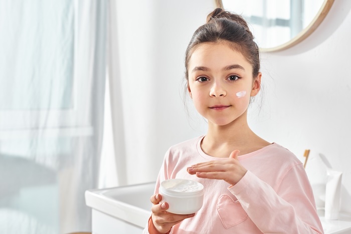 Young girl with an anti-aging product